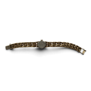 Seiko 11-0549 laid flat, showing the full gold-tone bracelet and the stainless steel caseback