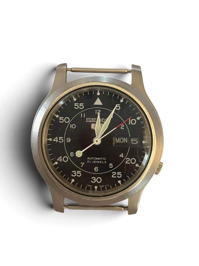 Seiko 5 SNK809 watch head with black military dial, day and date at 3 o'clock