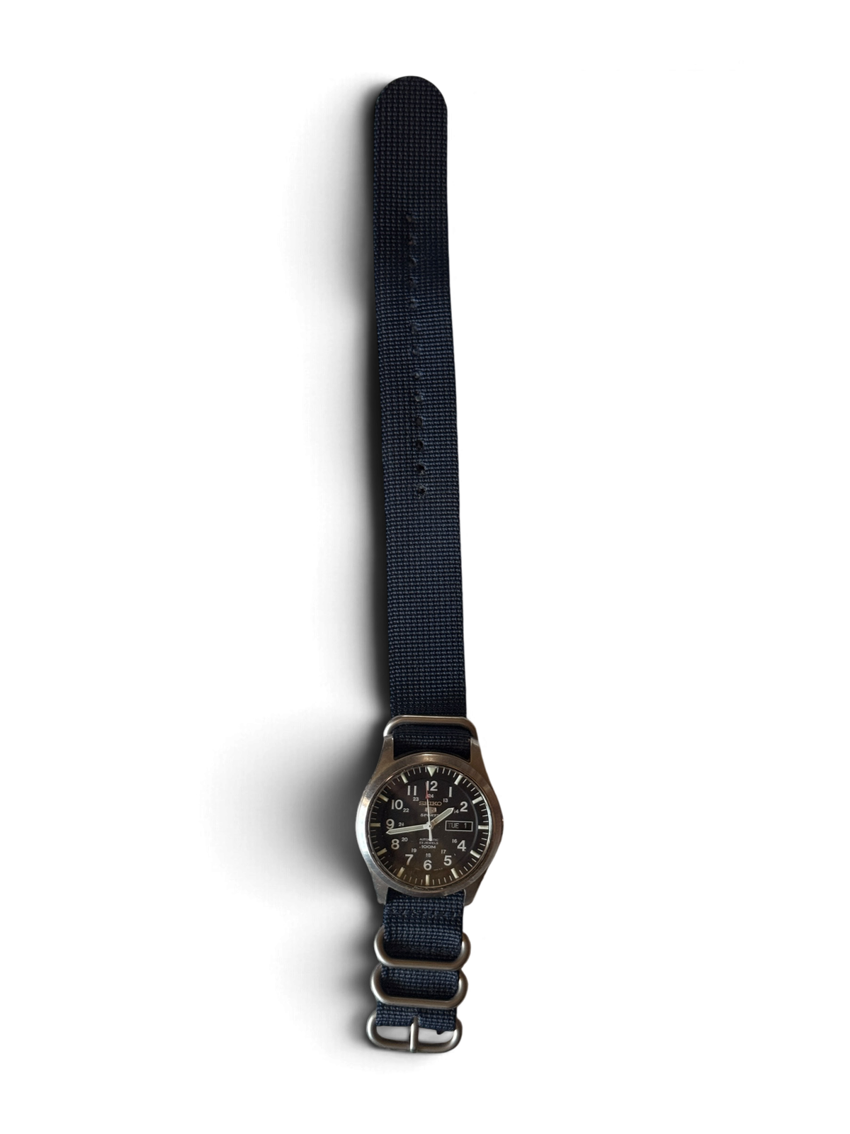 Seiko 5 Sports SNZG15 on the navy nylon zulu strap it ships with