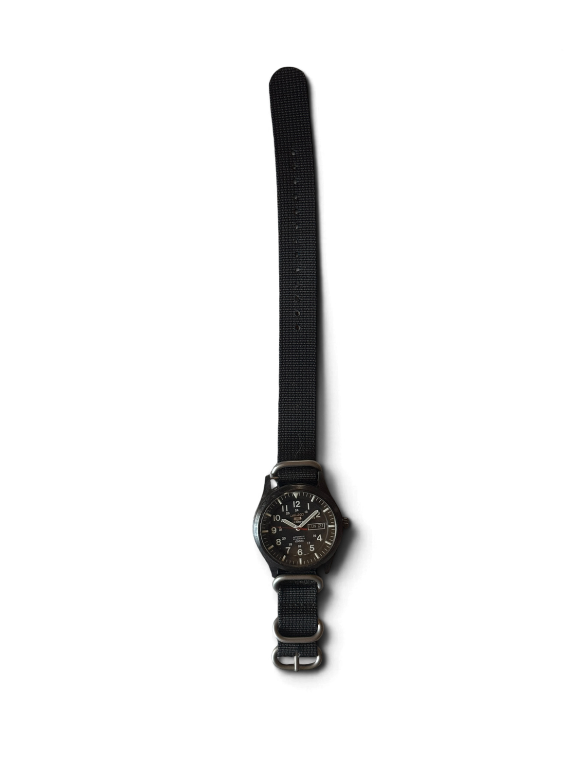 Seiko 5 Sports SNZG17 on the black nylon zulu strap it ships with